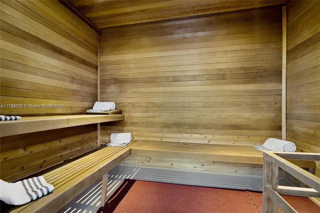 a view of a livingroom with lounge chair and a window