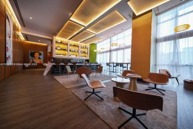 a lobby with furniture and a potted plant