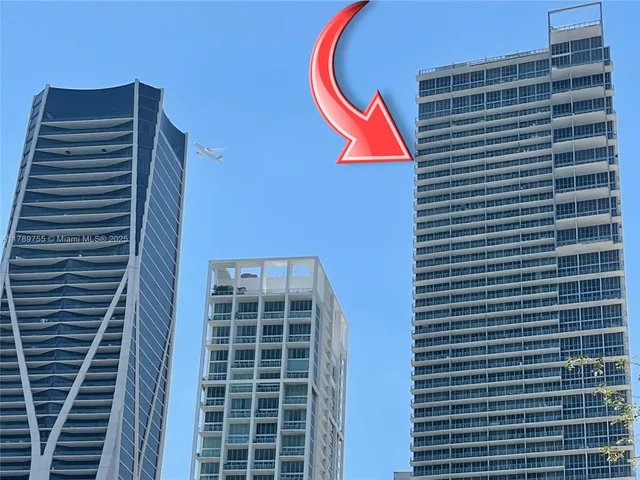 a living room with lots of furniture and a large window
