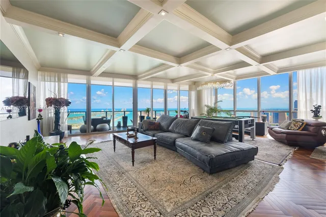 a living room with patio furniture and a large window