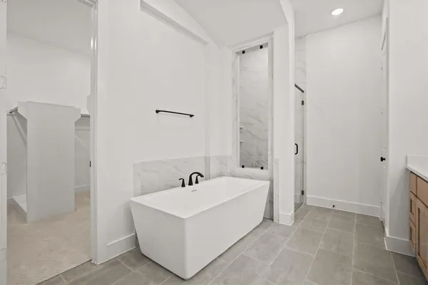 a white bath tub sitting next to a white sink