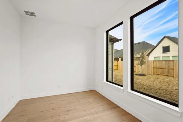 a view of hallway with wooden floor
