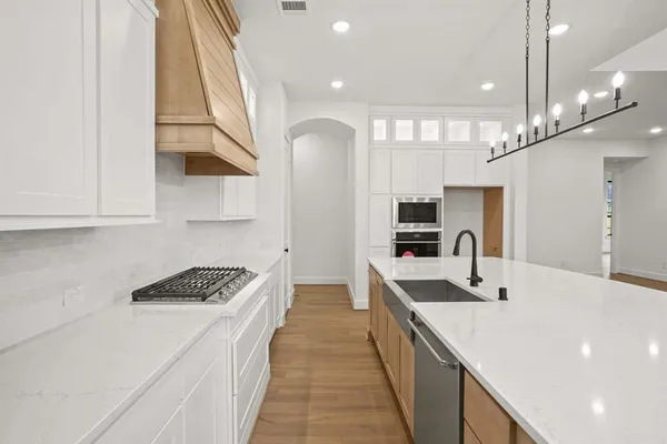 a kitchen with stainless steel appliances a sink and a stove