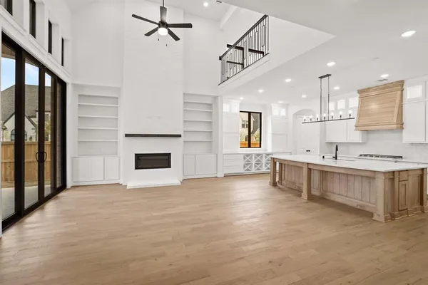 a large white kitchen with a large window