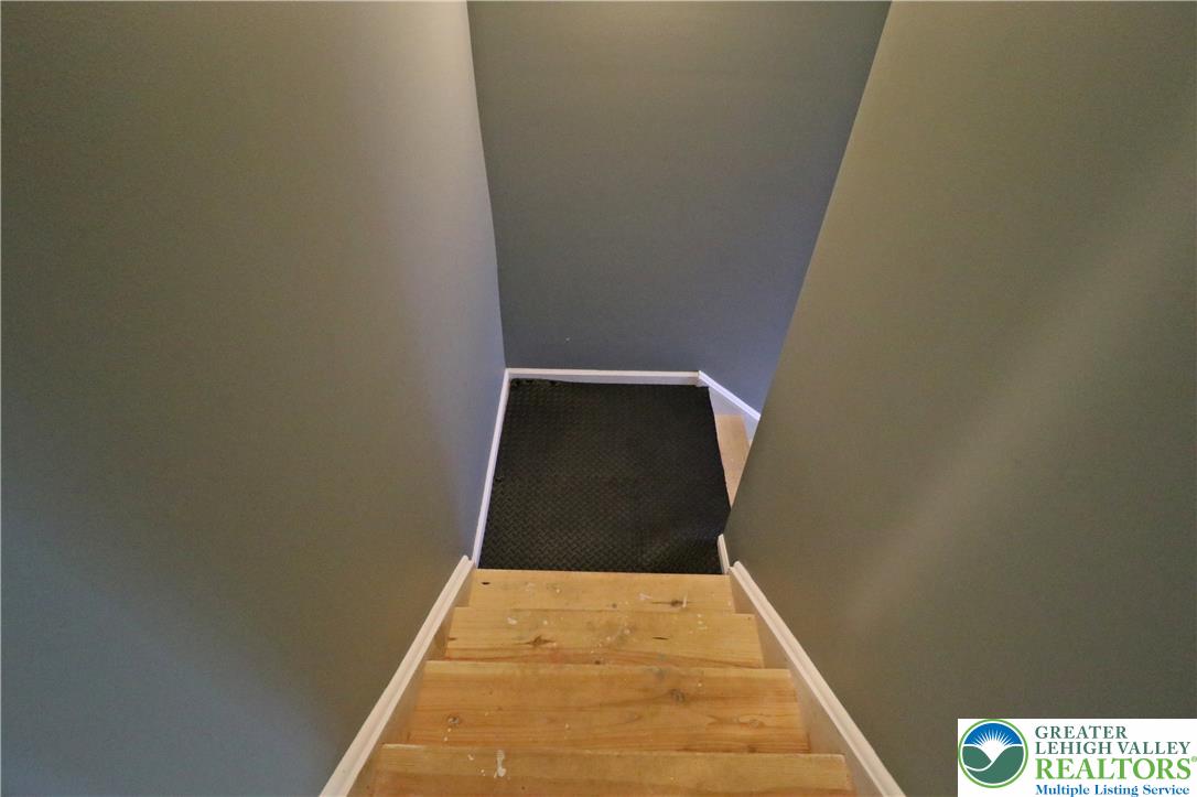 4502 Benjamin Court Emmaus, PA 18049 - Photo 40 of 53 Descend these robust wooden stairs into a versatile lower-level space.