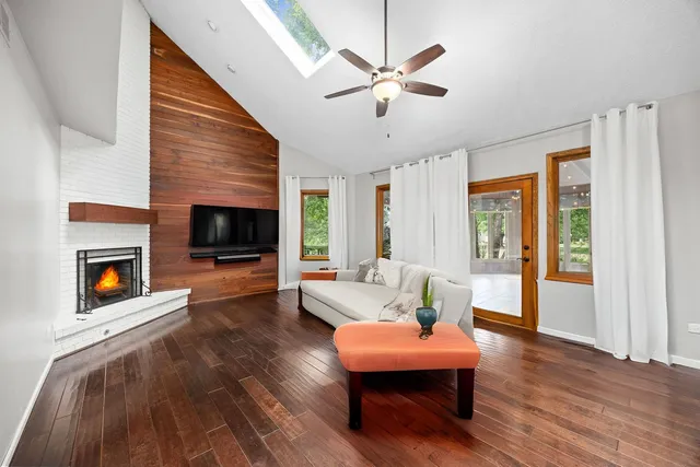a living room with furniture fireplace and flat screen tv