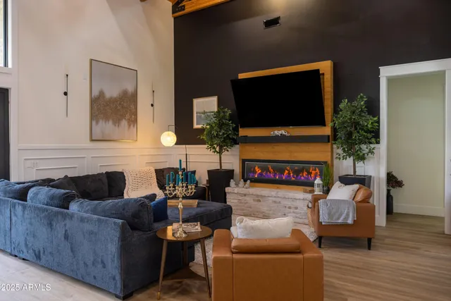 a large kitchen with stainless steel appliances kitchen island granite countertop a large stove a sink dishwasher and white cabinets with wooden floor