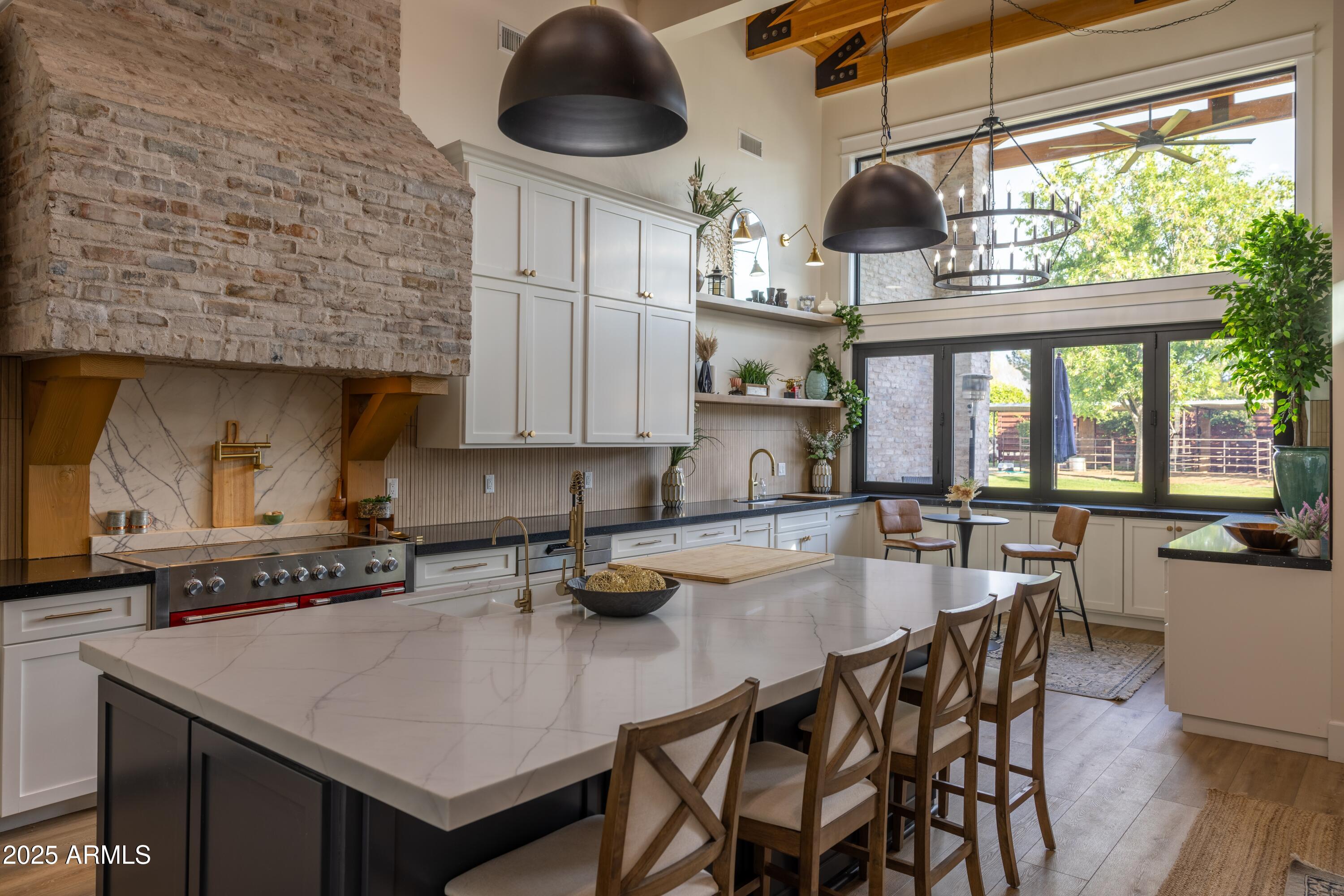 16322 East Fairview Street Gilbert, AZ 85295 - Photo 16 of 115 a kitchen with stainless steel appliances a table chairs and a wooden floor