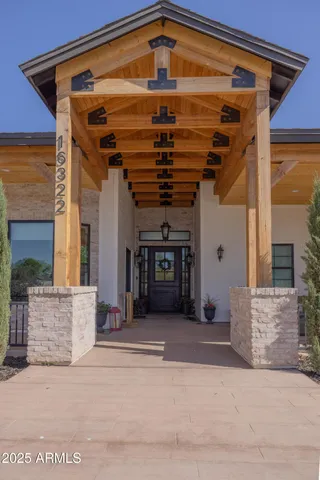 front view of a brick house with a bench