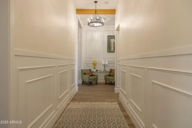 a living room with furniture and a flat screen tv with wooden floor