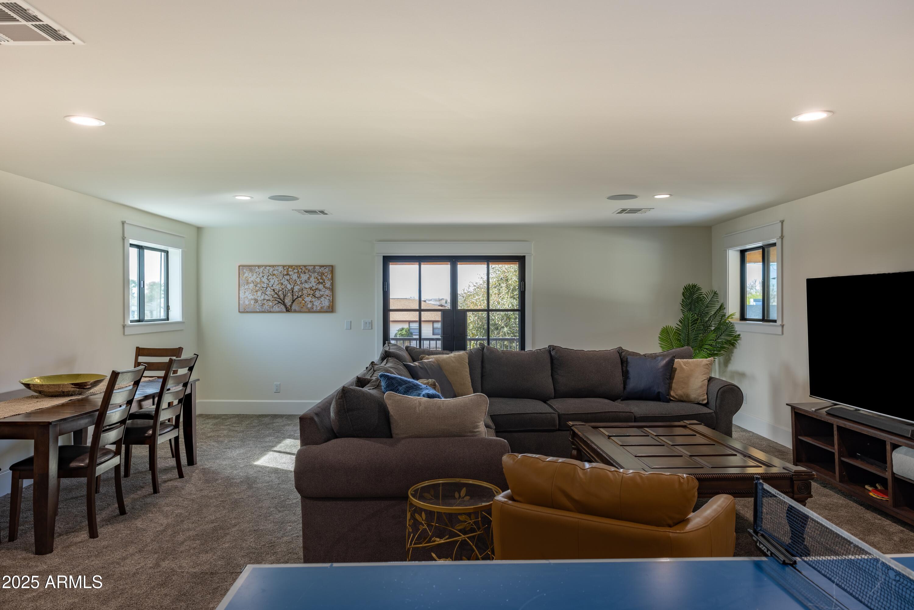 16322 East Fairview Street Gilbert, AZ 85295 - Photo 58 of 115 a living room with furniture and a flat screen tv with wooden floor