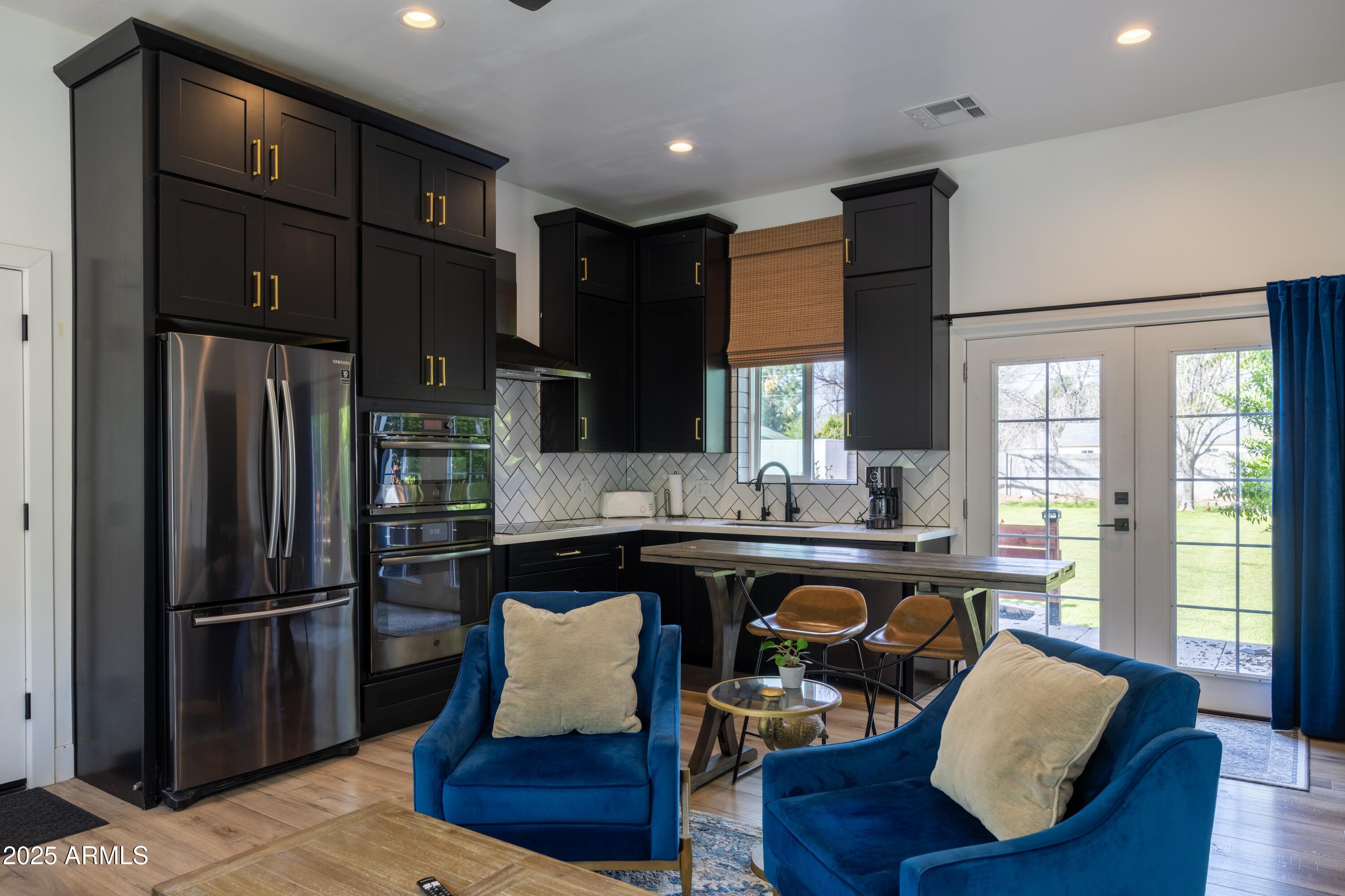 16322 East Fairview Street Gilbert, AZ 85295 - Photo 67 of 115 a kitchen with granite countertop wooden floors and refrigerator
