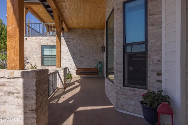 a kitchen with stainless steel appliances a table chairs and a wooden floor