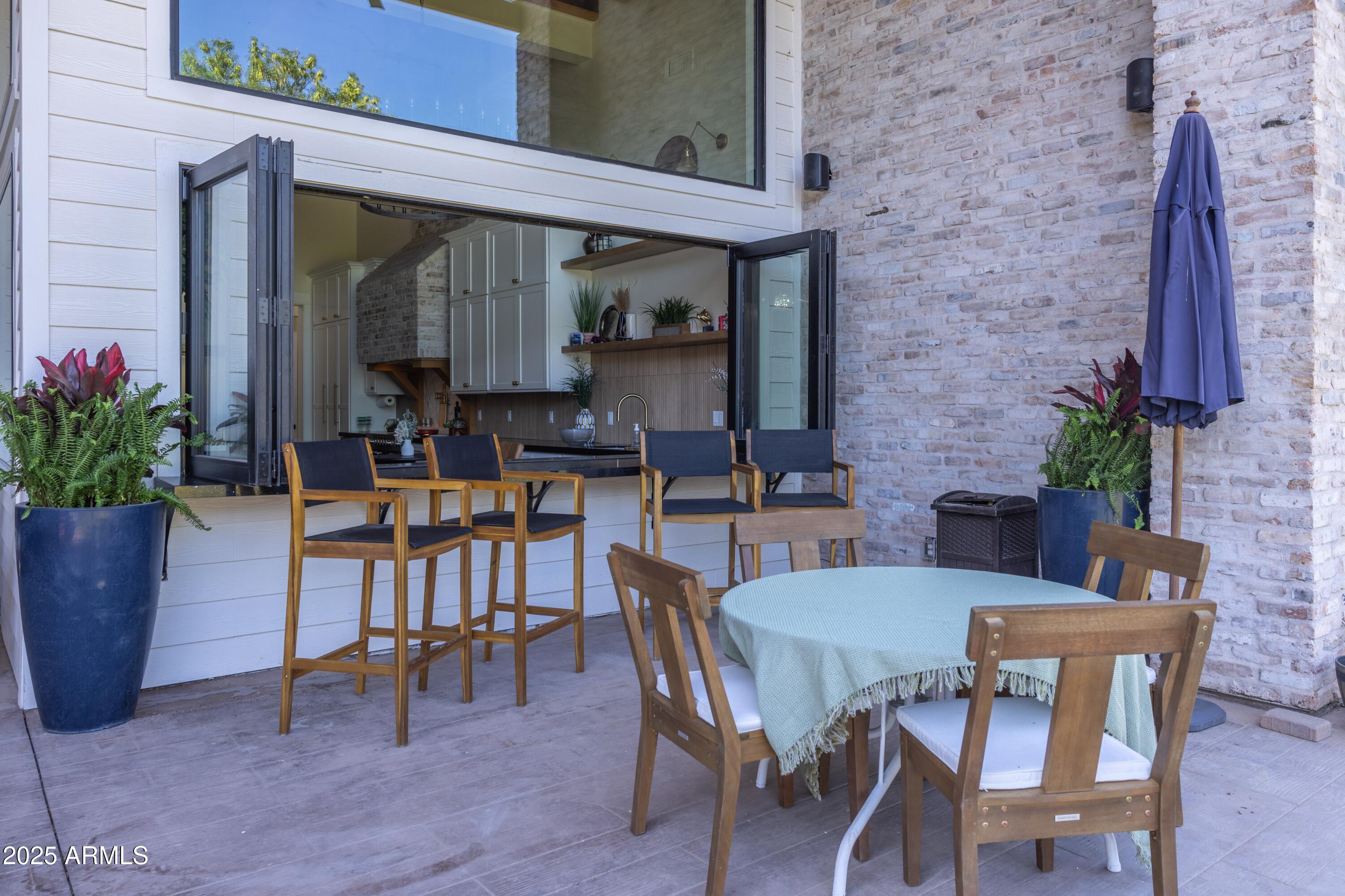 16322 East Fairview Street Gilbert, AZ 85295 - Photo 84 of 115 a view of a patio with table and chairs potted plants