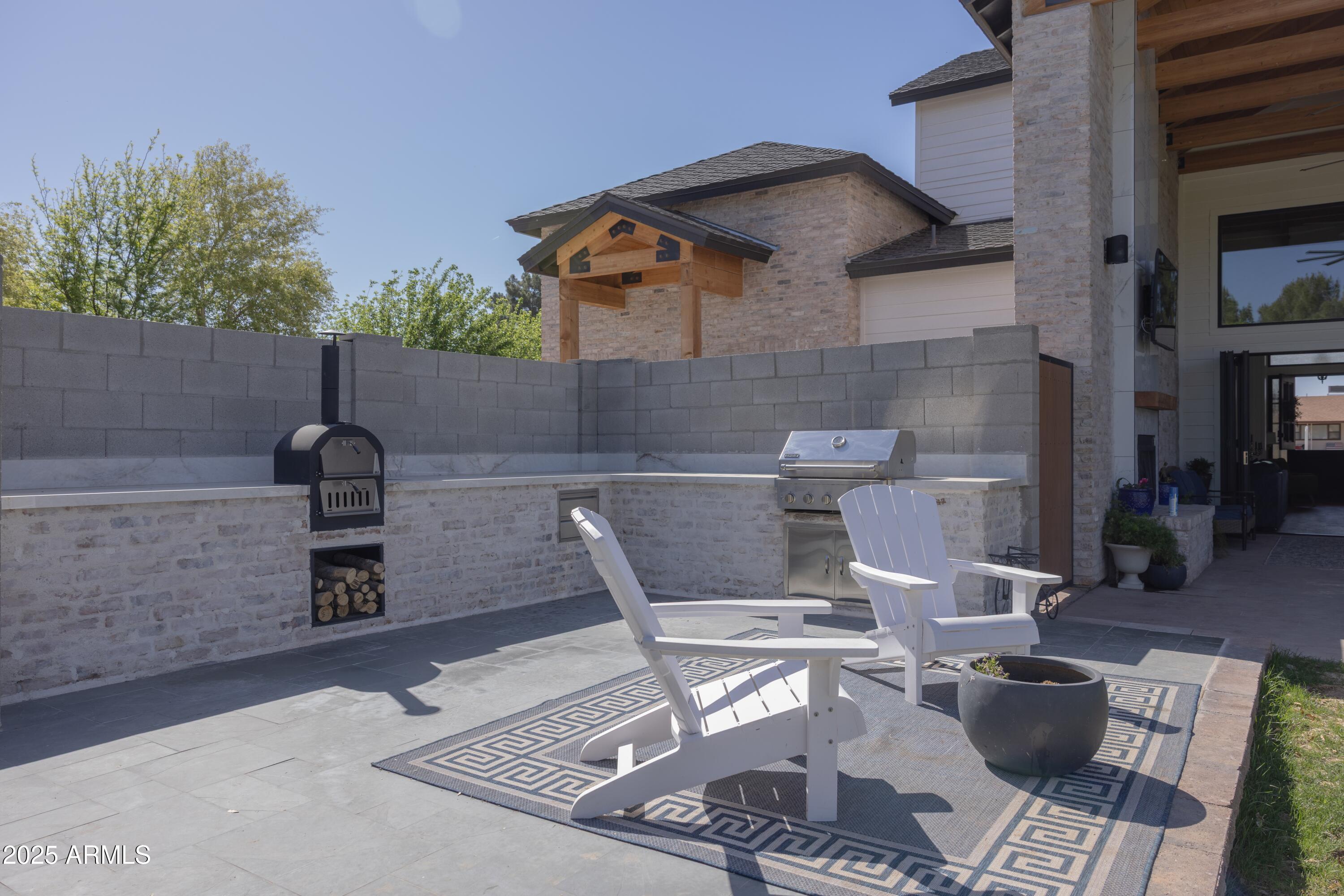 16322 East Fairview Street Gilbert, AZ 85295 - Photo 87 of 115 a view of a chairs and table in the back yard of the house