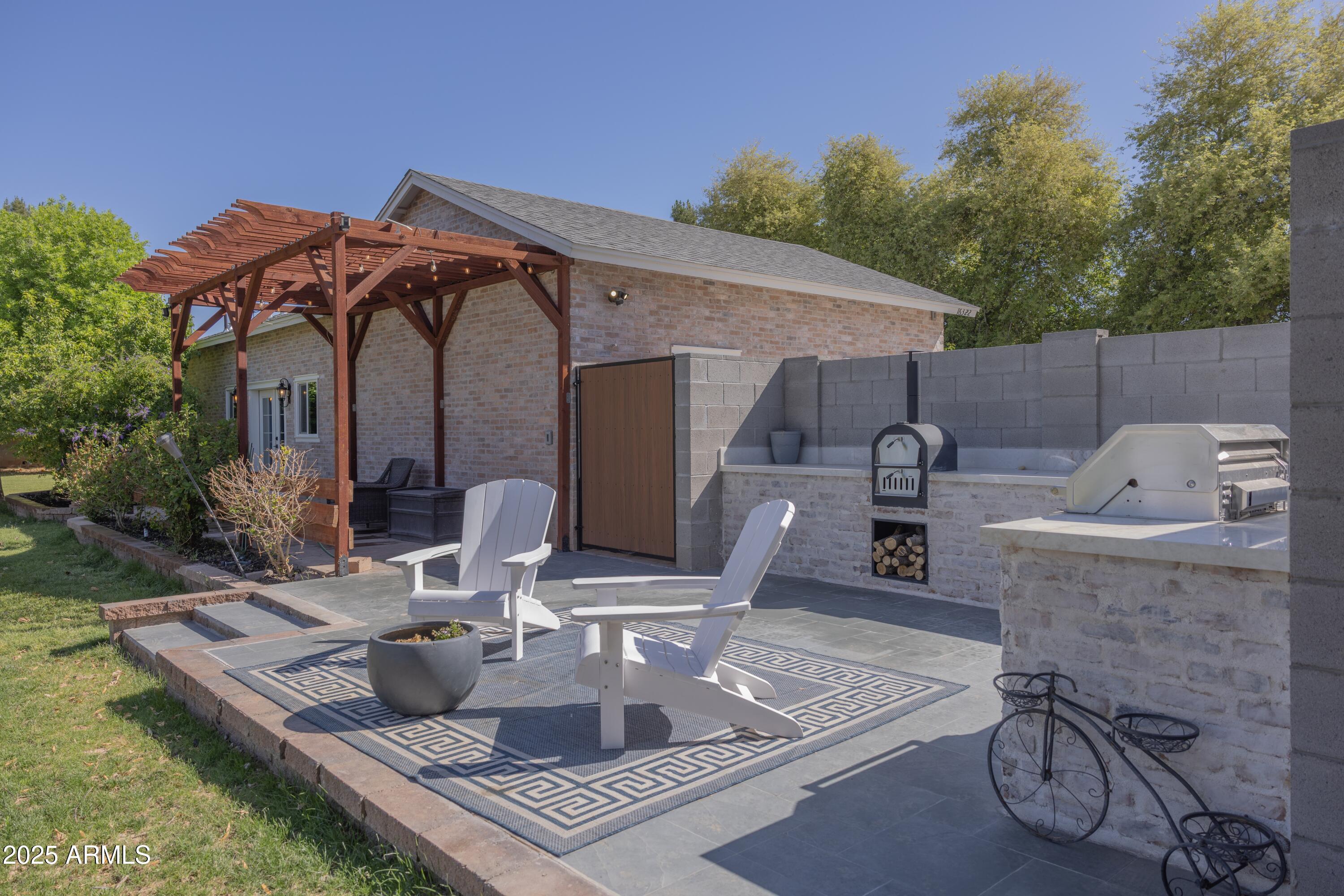 16322 East Fairview Street Gilbert, AZ 85295 - Photo 89 of 115 a view of a patio with table and chairs with wooden floor and fence