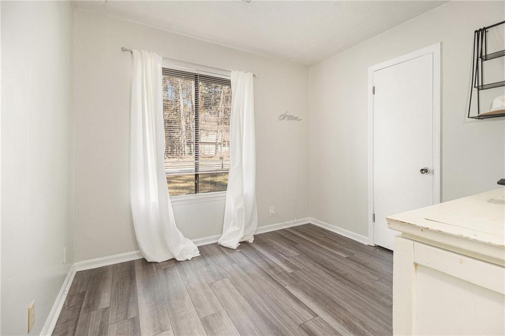 190 Kipling Way Riverdale, GA 30274 - Photo 15 of 22 an empty room with wooden floor and windows