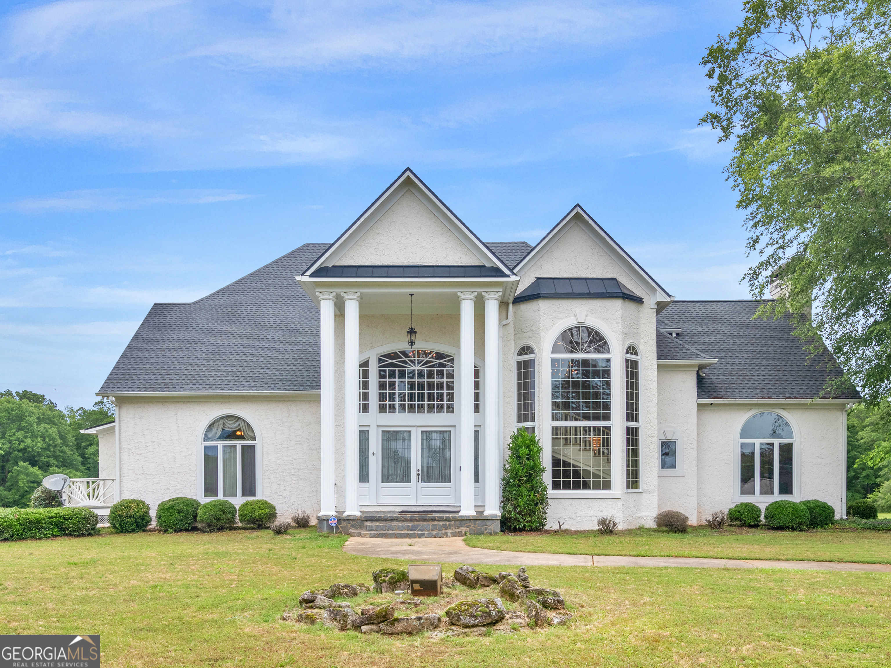 a front view of a house with a garden