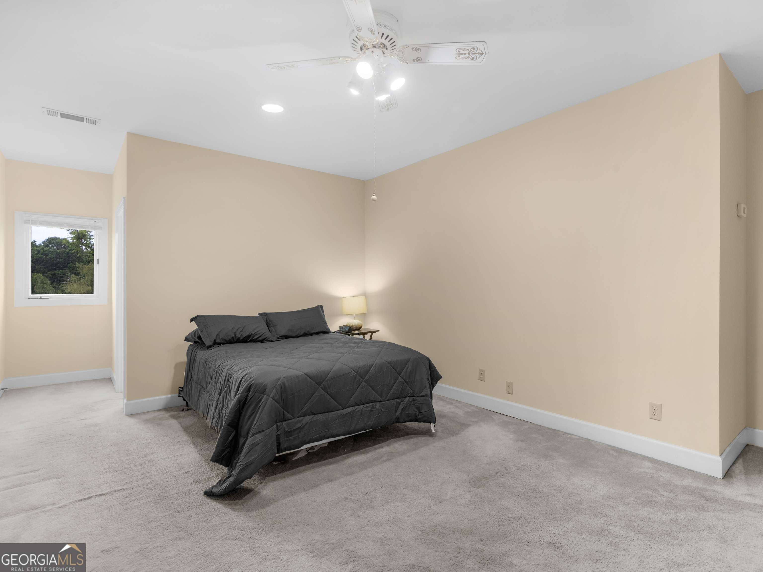 474 North Rover Road Williamson, GA 30292 - Photo 65 of 89 a bedroom with a bed and a night stand