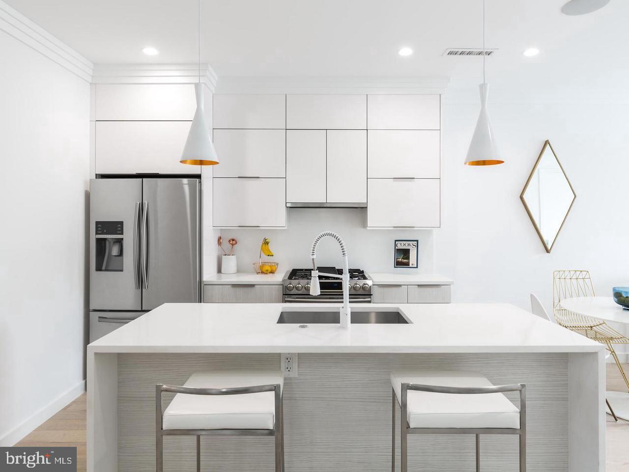 a kitchen with refrigerator a sink and a stove