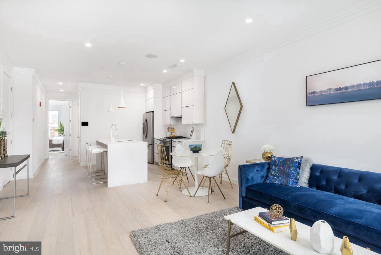 3527 14th Street Northwest, Unit 3 Washington, DC 20010 - Photo 2 of 12 a living room with furniture and a wooden floor