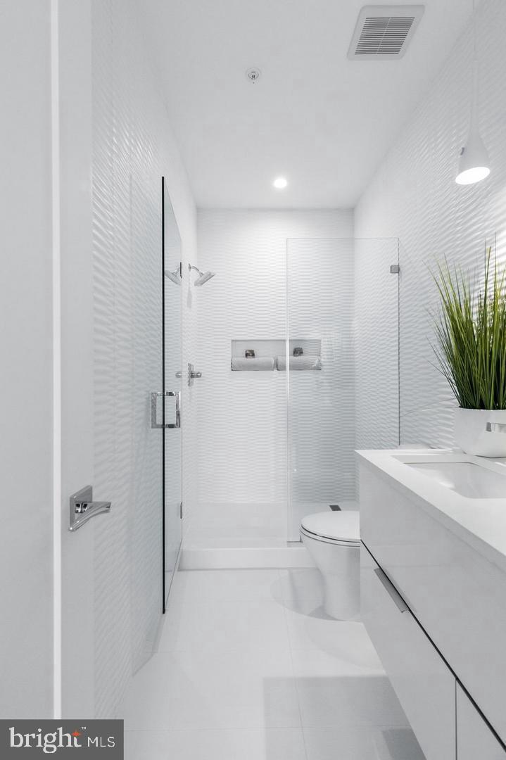 3527 14th Street Northwest, Unit 3 Washington, DC 20010 - Photo 7 of 12 a bathroom with a sink a toilet and shower