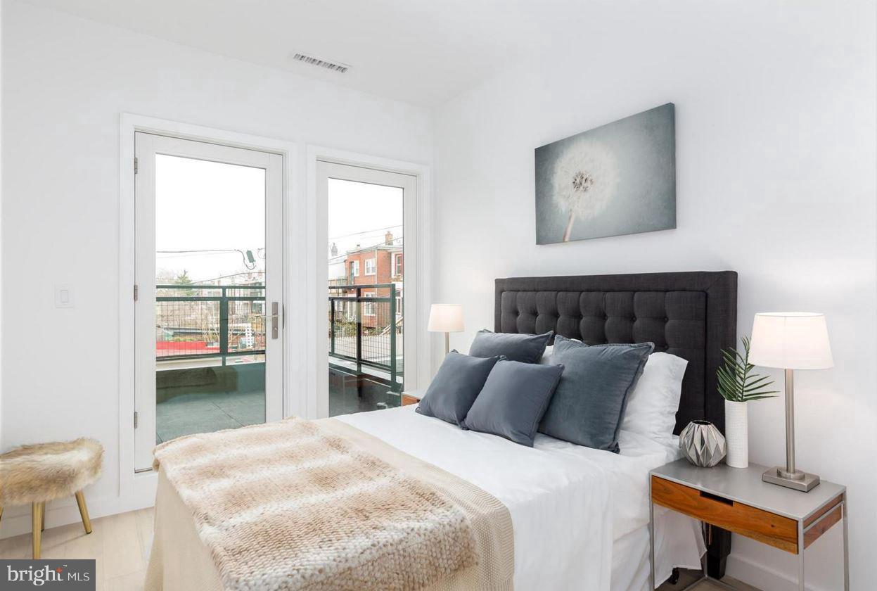 3527 14th Street Northwest, Unit 3 Washington, DC 20010 - Photo 8 of 12 a bedroom with a bed and a window