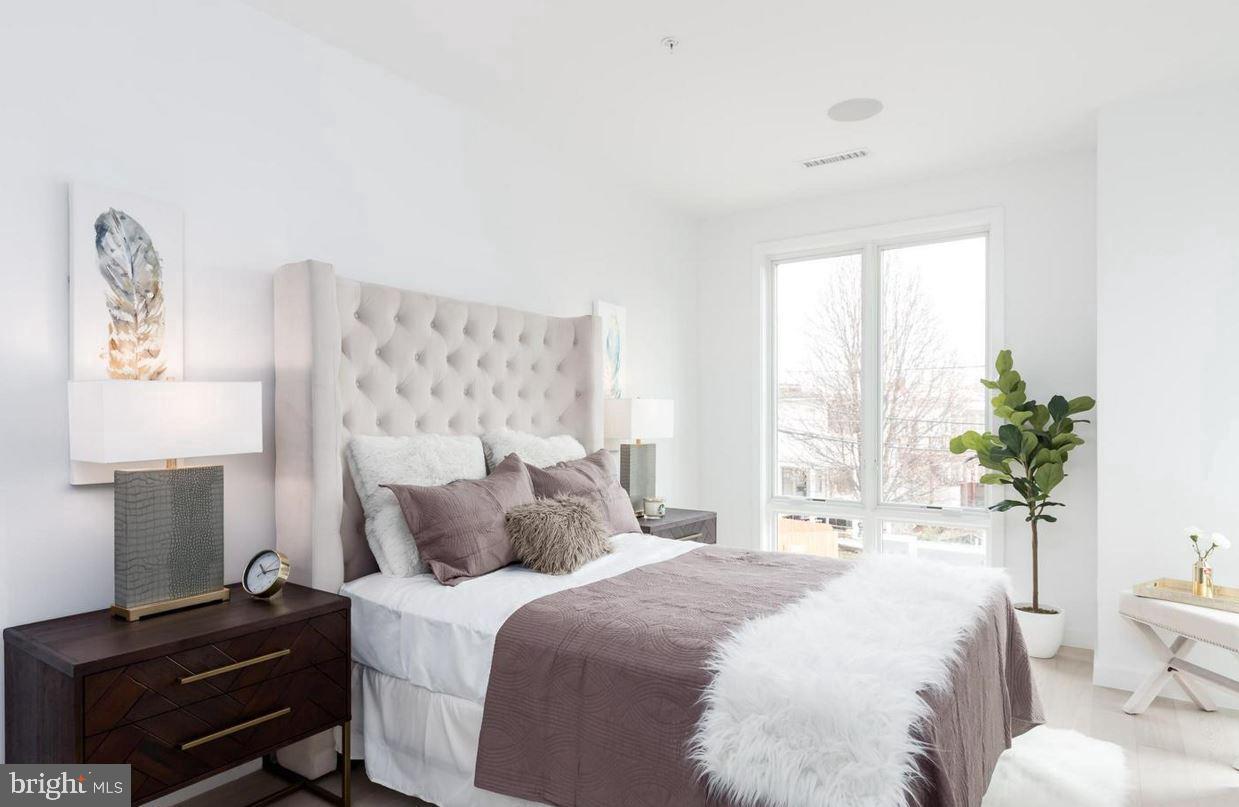 3527 14th Street Northwest, Unit 3 Washington, DC 20010 - Photo 9 of 12 a bedroom with a bed and a lamp on dresser