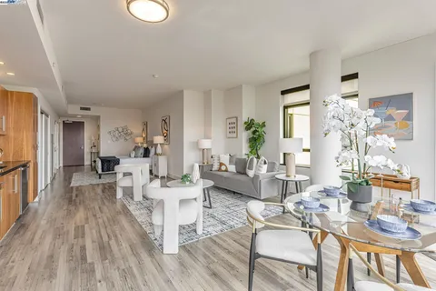 a living room with furniture dining table and wooden floor