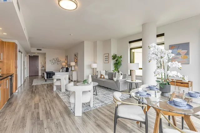 a living room with furniture dining table and wooden floor