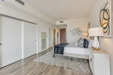 a bedroom with a bed and wooden floor