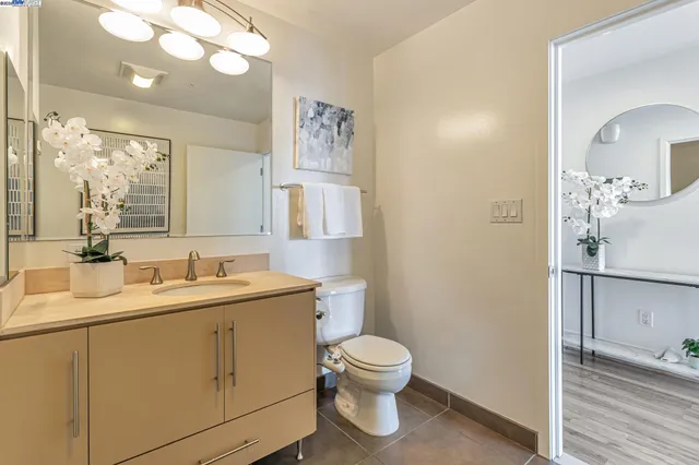 a bathroom with a toilet sink and mirror