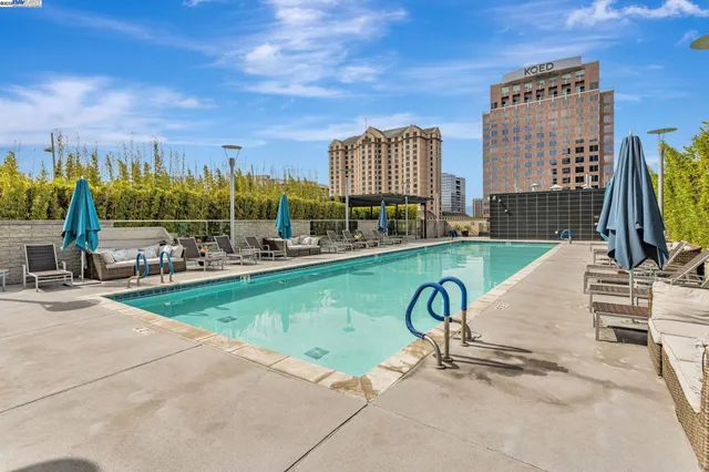 a view of a swimming pool with a patio and couches