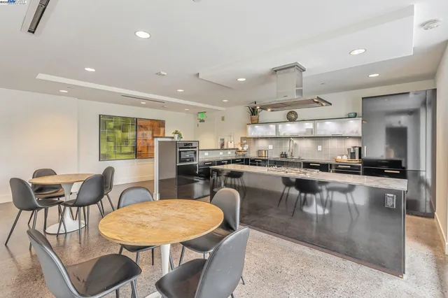 a kitchen with a dining table chairs stove dining table and chairs