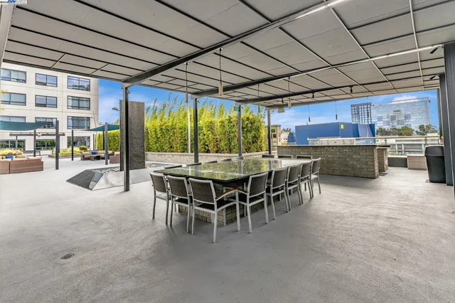 a view of a patio with dining table and chairs