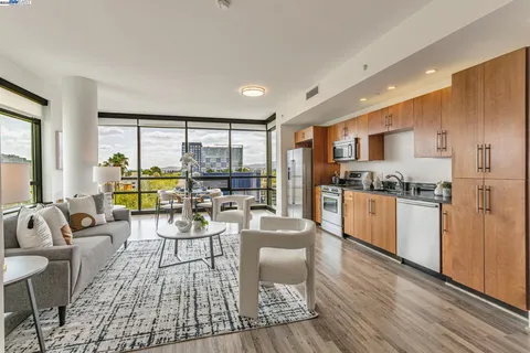 a kitchen with a table chairs refrigerator and cabinets