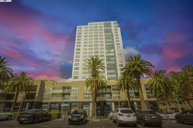 a city street lined with parked cars and buildings