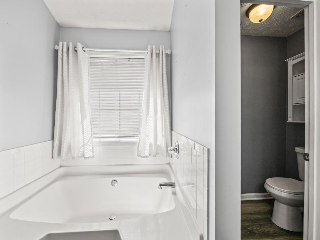 95 Ridge Water Lane Dawsonville, GA 30534 - Photo 20 of 45 a bathroom with a tub and a window
