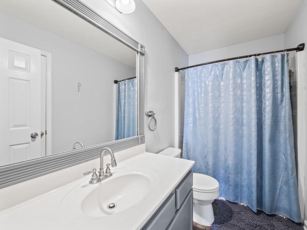 95 Ridge Water Lane Dawsonville, GA 30534 - Photo 28 of 45 a bathroom with a sink a toilet and shower curtain