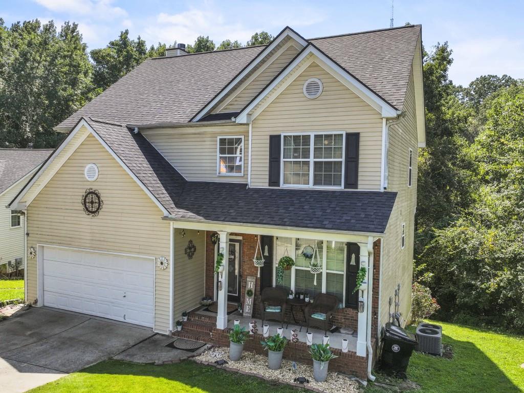 95 Ridge Water Lane Dawsonville, GA 30534 - Photo 3 of 45 a view of a brick house with a yard potted plants and a table and chair