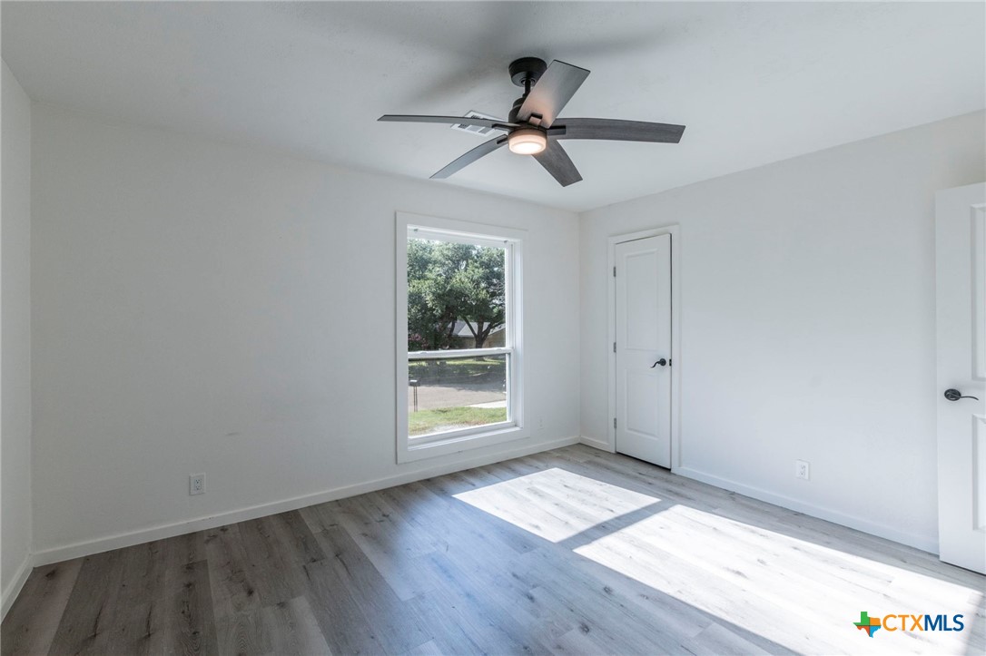 4013 Valley View Drive Temple, TX 76502 - Photo 12 of 25 a view of empty room with wooden floor and fan