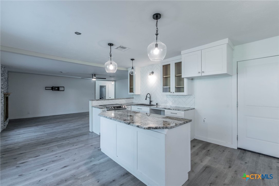 4013 Valley View Drive Temple, TX 76502 - Photo 6 of 25 a kitchen with stainless steel appliances granite countertop a sink a stove and a wooden floors