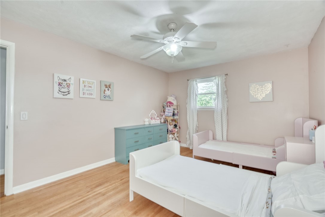 1038 Whalen Road Penfield, NY 14526 - Photo 26 of 46 Bedroom number three with ceiling, fan and hardwoo