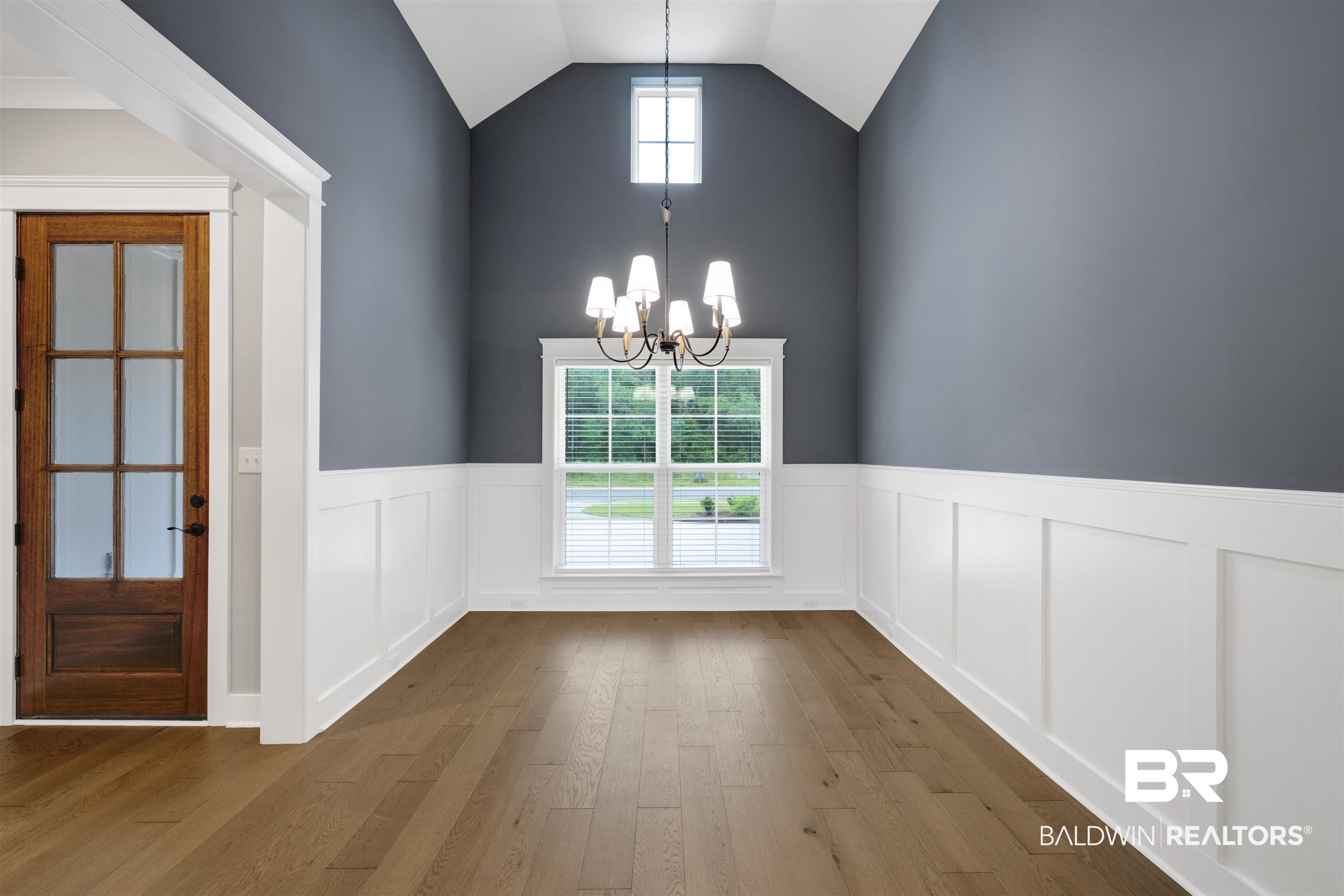 27371 Patch Pl Loop Daphne, AL 36526 - Photo 18 of 63 Vaulted ceiling with a chandelier, wood-finish flooring, wainscoting, and large window with blinds