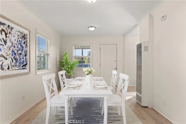 a view of a dining room with furniture window and wooden floor