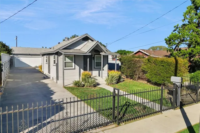 a front view of a house with wooden fence