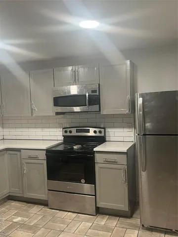 a kitchen with a stove cabinets and refrigerator