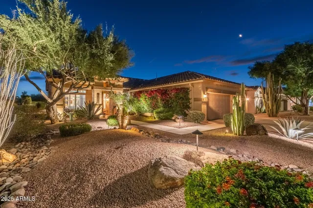 a view of a backyard with table and chairs under an umbrella
