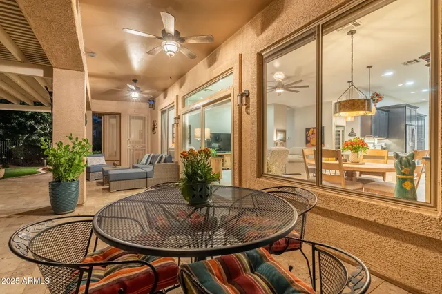 a view of a patio with a table and chairs and potted plants