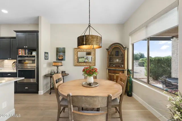 a dining room with furniture and wooden floor